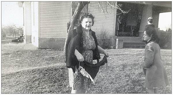 Mrs. Mae S. Thompson with her daughter Dixie in front of their home in Dyer